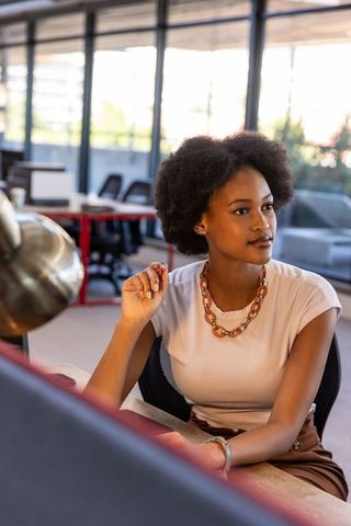 Business Professional Woman Gazing at Computer Screen in Minimalistic Office