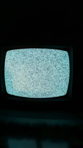 Vertical Vintage CRT TV Cycling Through Dense Blue-Gray Static in Dark Room
