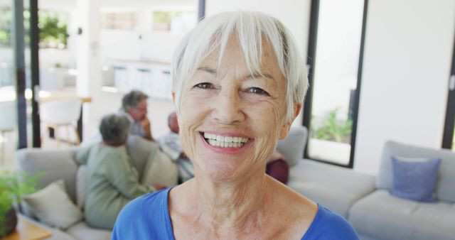 Portrait of happy senior caucasian woman with other seniors at retirement home. healthy, active retirement and body inclusivity.