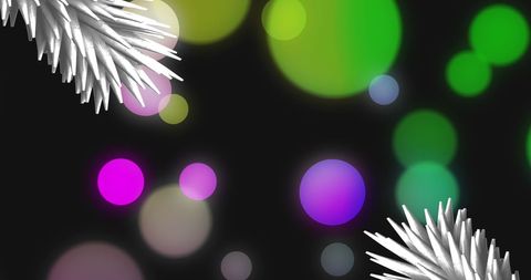 Festive evergreen branches with colorful bokeh lights