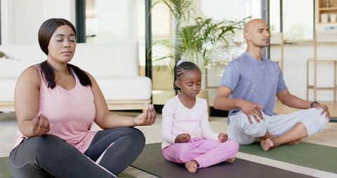 Family Practicing Mindful Meditation Together at Home on Yoga Mats — Wellness Lifestyle