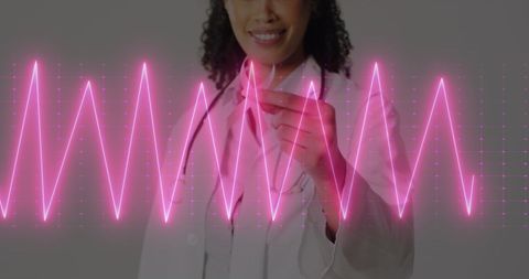 Doctor Holding Pink Ribbon with Heart Rate Overlay for Cancer Awareness - Download Free Stock Images Pikwizard.com