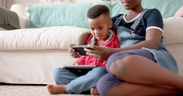 Sibling Bonding, Boy Using Digital Tablet While Sister Helps - Download Free Stock Images Pikwizard.com