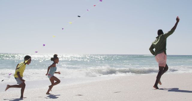 Family Enjoying Kite Flying on Sunny Beach - Download Free Stock Images Pikwizard.com