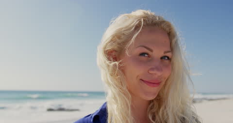 Smiling Blond Woman Enjoying Sunny Beach Day