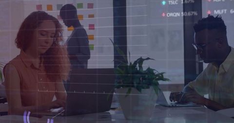 Working Professionals Collaborating with Data Dashboard and Laptops in Glass Office Space