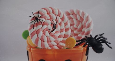 Halloween candy bucket with candy and spiders