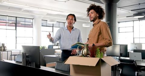 New Employees Unpacking Boxes Boosting Team Spirit in Modern Office