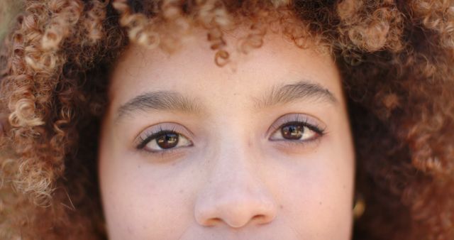 Close-up on Face with Brown Curly Hair and Bright Eyes - Download Free Stock Images Pikwizard.com