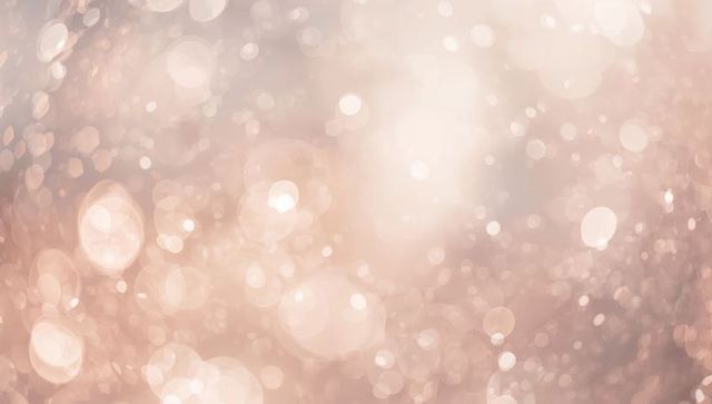 Rose gold bokeh glow with soft sparkles and dreamy light orbs