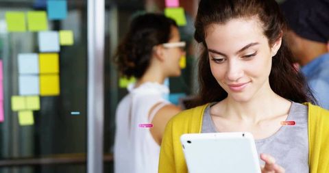 Young Professional Collaborating in Creative Office with Tablet