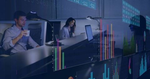Finance team collaborating and analyzing market data on trading desk with dashboards