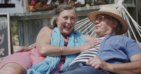 Happy Seniors Enjoying Hammock Relaxation on Beach