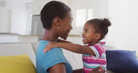 Joyful Mom and Daughter Embracing at Home on Sofa - Download Free Stock Images Pikwizard.com