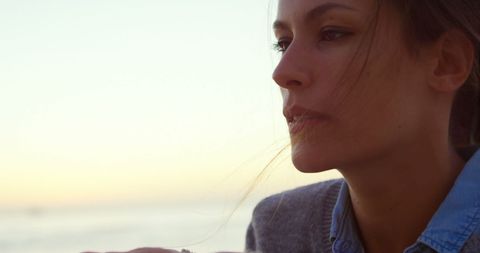 Pensive Woman Gazing at Serene Sunset Beach - Download Free Stock Images Pikwizard.com