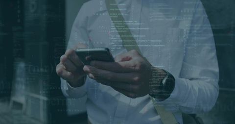 Tapping businessman using smartphone with code overlay in corporate lobby