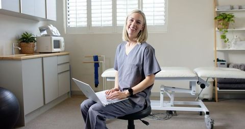 Healthcare Professional Engaging with Laptop in Prosthetics Lab