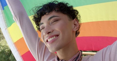 Joyous Celebration with Rainbow Pride Flag in Park