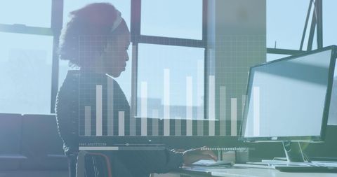 African american businesswoman analyzing data on computer in office