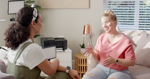 Diverse women collaborating in cozy living room workspace
