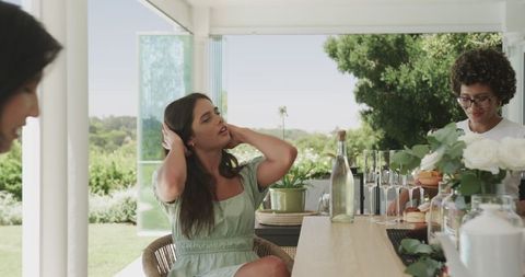 Women Sharing Laughs and Bonding Over Lunch Outdoors