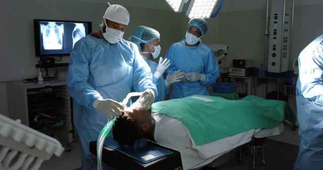 Diverse surgeons during surgery on african american male patient with oxygen mask. Medicine, healthcare, surgery and hospital, unaltered.