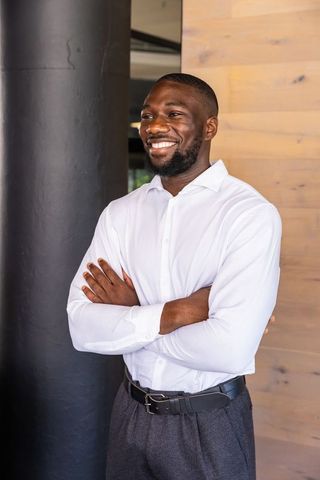 Confident Professional Smiling Man in Modern Interior