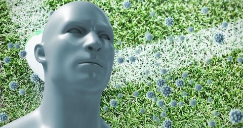 Abstract sculpture in grass with floating spheres