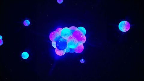 Neon cosmic orb cluster glowing cyan and magenta against deep space starfield