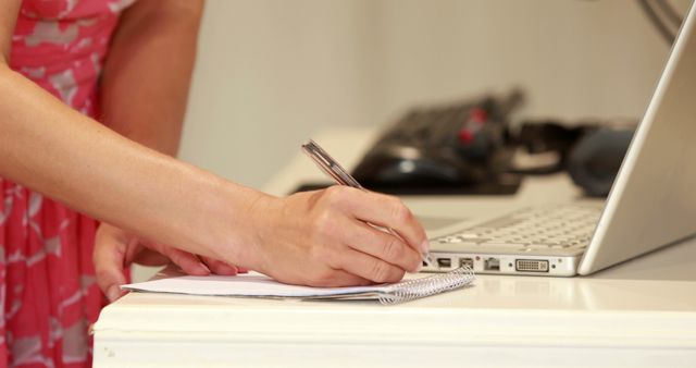 Woman Writing Notes Next to Laptop - Download Free Stock Images Pikwizard.com