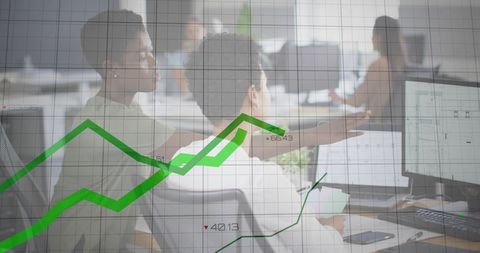 Colleagues Analyzing Data Visualization on Computer