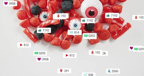 Social media notification candy flatlay featuring red licorice, nonpareil gummies, eyeballs