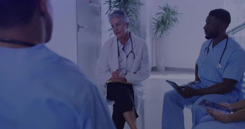 Senior Doctor Leading Medical Team Discussion in Hospital