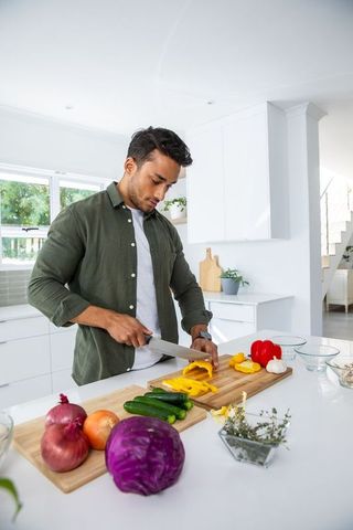 Man Preparing Healthy Meal with Fresh Vegetables in Modern Kitchen