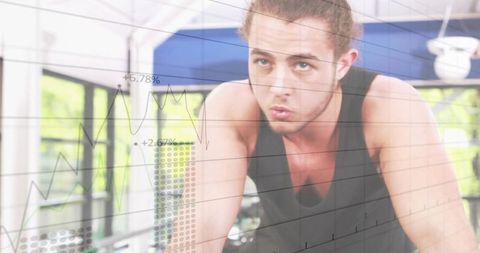 Man Cycling in Gym with Financial Chart Overlay for Motivation