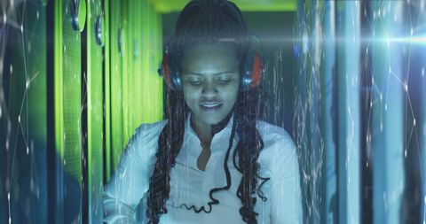 Female IT Professional Analyzing Data in Modern Server Room