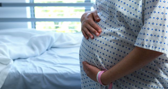 Pregnant Woman in Hospital Gown Touching Belly - Download Free Stock Images Pikwizard.com