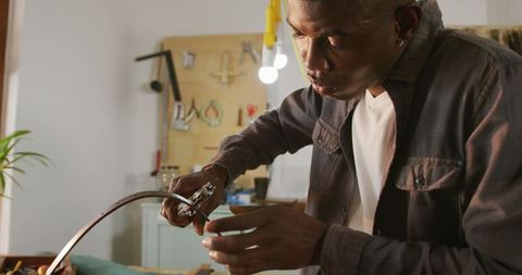 Focused Craftsman Creating Leatherwork Using Precision Tools