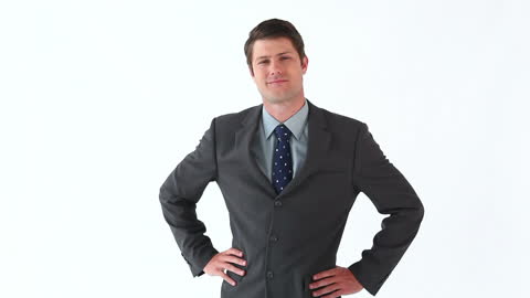 Confident Businessman with Hands on Hips against White