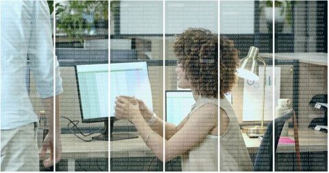 Coworkers discussing data analysis on computer in modern office