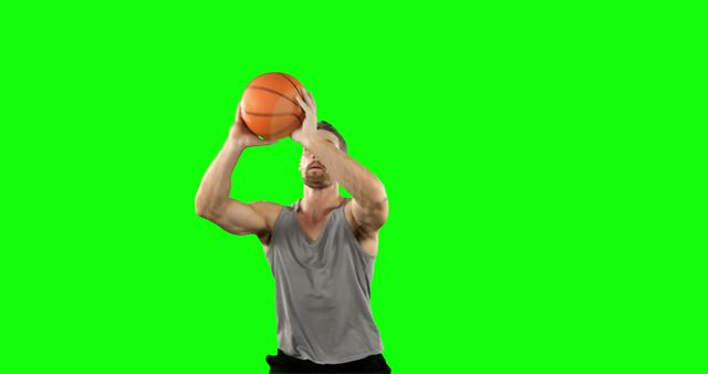 Player playing basketball against green screen