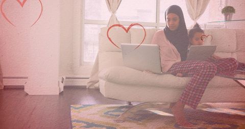 Mother and Daughter with Technology Surrounded by Love Hearts