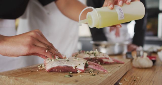 Chefs Preparing Lamb Chops with Olive Oil and Herbs in Professional Kitchen - Download Free Stock Images Pikwizard.com