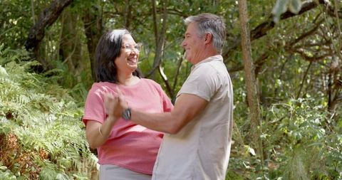 Senior Couple Dancing in Forest Embracing Romantic Moment