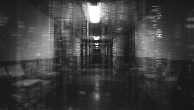 Haunting monochrome hospital corridor leading to distant doorway with light streaks, glitch