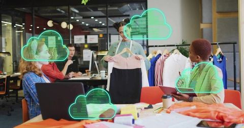 Female fashion designer displaying dress in modern office