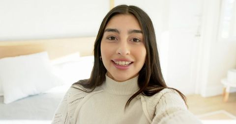 Woman Smiling in Cozy Minimalist Bedroom Interior