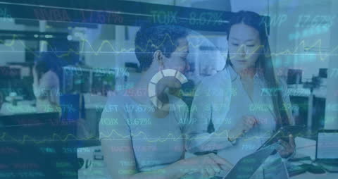 Business Colleagues Analyzing Financial Data with Digital Overlay