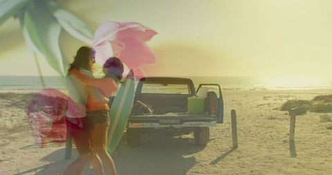 Couple embracing on sunlit beach with pickup truck, surfboard and floral overlay