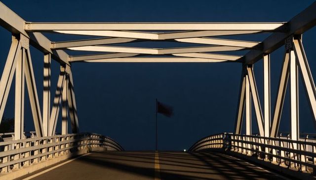 Nighttime White Steel Truss Bridge Casting Long Shadows and Geometric Patterns